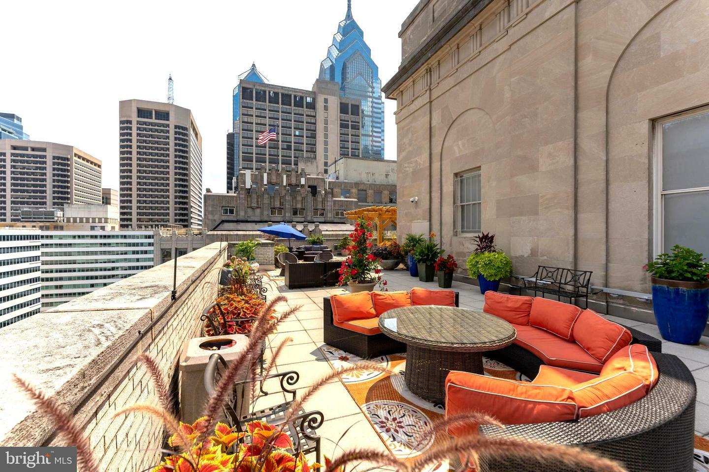 Stunning rooftop terrace in Philadelphia, beautifully landscaped with lush greenery and offering sweeping city views.
