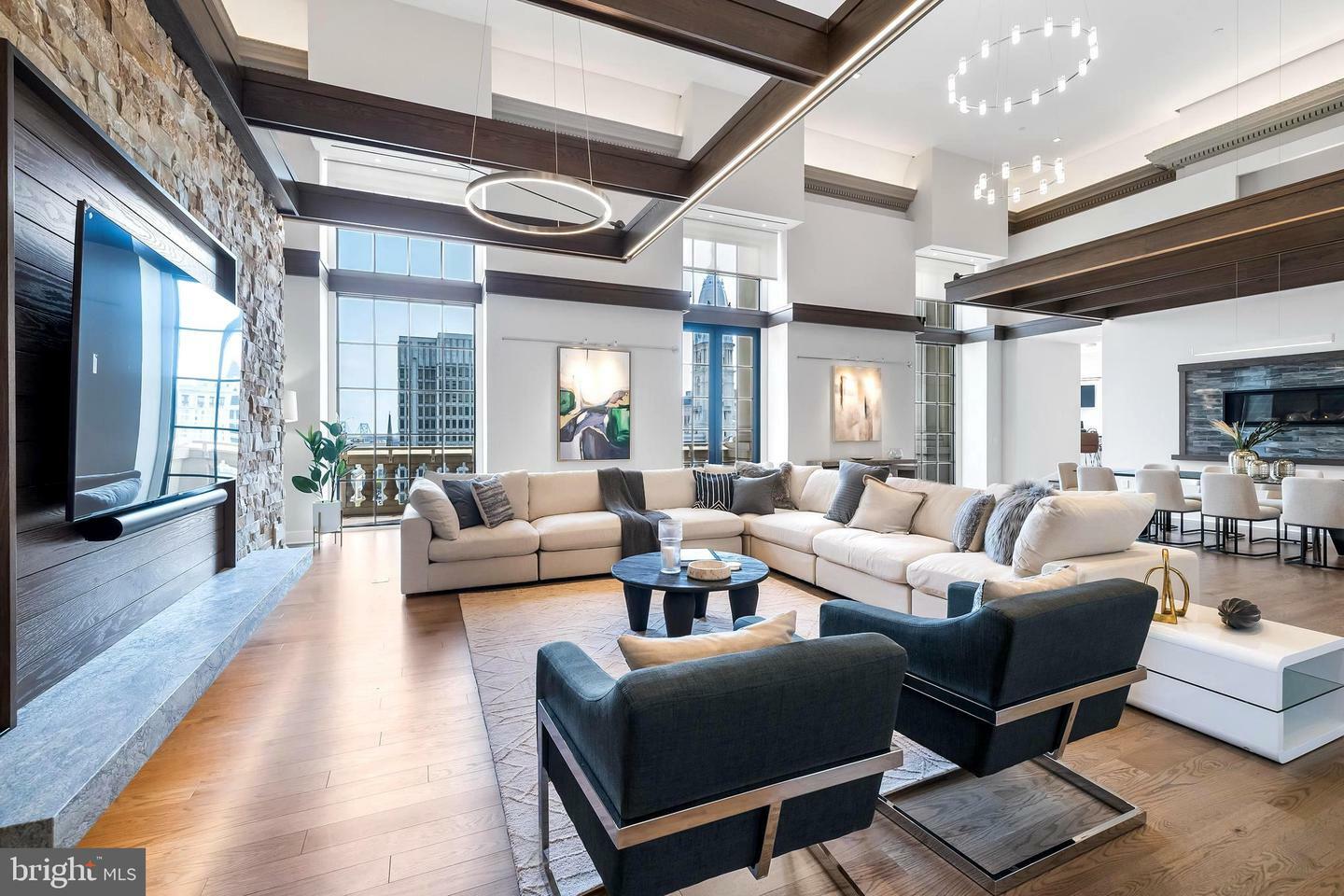 Elegant and spacious living room in a modern Philadelphia apartment showcasing contemporary decor and large windows with city views.