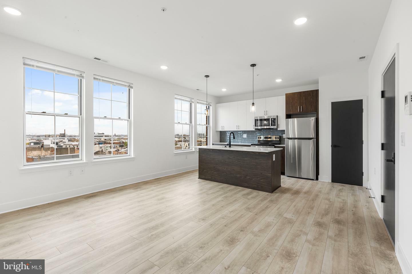 Spacious and well-equipped kitchen in a Philadelphia rental, showcasing stainless steel appliances and granite countertops.