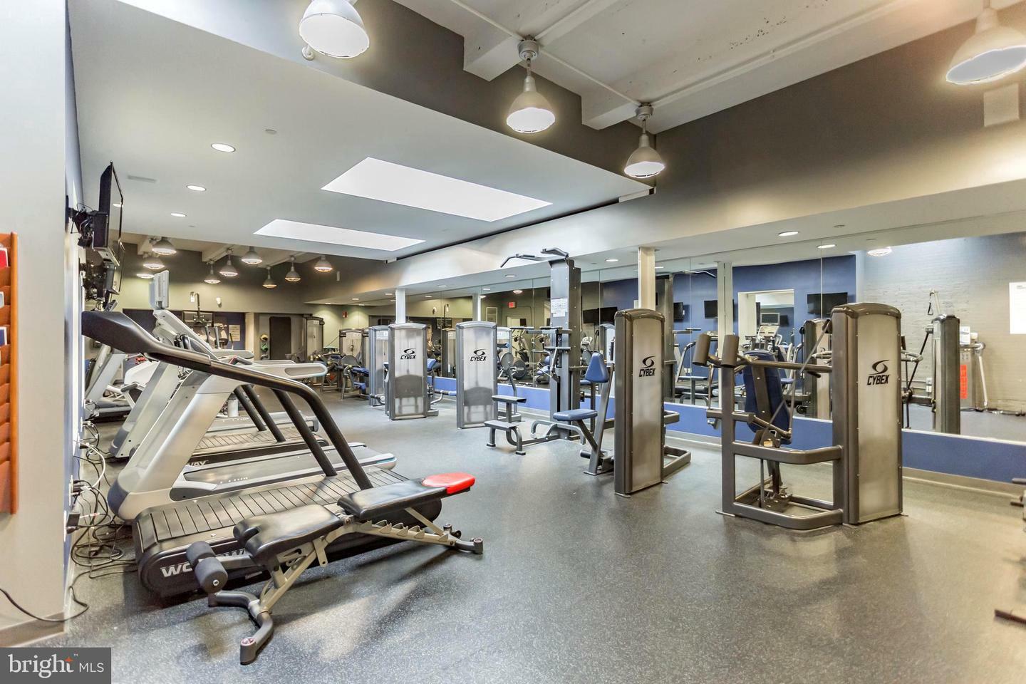 State-of-the-art gym facility in a Philadelphia apartment complex, featuring modern equipment and spacious layout.